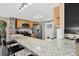 Kitchen with breakfast bar featuring granite countertops and stainless steel appliances at 8340 London Ln, Conifer, CO 80433