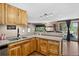 Charming kitchen featuring wood cabinets, granite countertops, and views to the deck at 8340 London Ln, Conifer, CO 80433