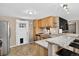 Functional kitchen with wood cabinets, tile flooring, granite countertop, and stainless steel appliances at 8340 London Ln, Conifer, CO 80433