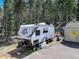 Recreational vehicle or trailer parked on paved space near a shed, ready for adventures at 8340 London Ln, Conifer, CO 80433