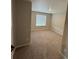 Bedroom featuring neutral carpeting and a window, offering a comfortable living space at 9353 Yampa Ct, Commerce City, CO 80022