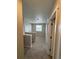 Upstairs hallway with carpet and doors to bedrooms at 9353 Yampa Ct, Commerce City, CO 80022