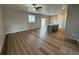 Open living area with kitchen island and wood flooring at 9353 Yampa Ct, Commerce City, CO 80022