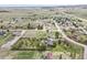 Aerial view of a single-Gathering home in a quiet neighborhood, featuring mature trees and landscaping at 34101 Columbine E Trl, Elizabeth, CO 80107
