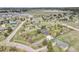 Community aerial view showcasing homes on large lots with mature trees and distant mountain views in the background at 34101 Columbine E Trl, Elizabeth, CO 80107