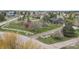 Aerial view of property with mature trees, lawn, a white fence and gravel drive in a quiet neighborhood at 34101 Columbine E Trl, Elizabeth, CO 80107
