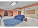Spacious basement featuring a blue sofa, carpet, and various activity areas at 34101 Columbine E Trl, Elizabeth, CO 80107