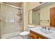 Bathroom featuring tiled shower, toilet, and a vanity with a sink and mirror at 34101 Columbine E Trl, Elizabeth, CO 80107