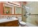 Bathroom with tiled shower, toilet, vanity with sink, and multiple mirrors at 34101 Columbine E Trl, Elizabeth, CO 80107