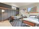 Bedroom with two beds, a black accent wall, and a diamond-patterned area rug at 34101 Columbine E Trl, Elizabeth, CO 80107