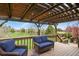 Relaxing covered outdoor deck area with comfortable wicker seating at 34101 Columbine E Trl, Elizabeth, CO 80107