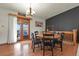 Dining room with a round table, dark accent wall, and access to the deck through glass doors at 34101 Columbine E Trl, Elizabeth, CO 80107