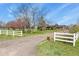 Charming single-Gathering home with a gravel driveway and a well-maintained front yard with mature trees at 34101 Columbine E Trl, Elizabeth, CO 80107
