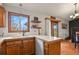 Bright kitchen with wood cabinets, white countertops, and a window overlooking the outdoors at 34101 Columbine E Trl, Elizabeth, CO 80107