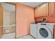 Laundry area with washer and dryer, storage cabinets, and a view to the bathroom at 34101 Columbine E Trl, Elizabeth, CO 80107