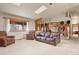 Cozy living room with a vaulted ceiling, skylight and natural light, and comfortable seating at 34101 Columbine E Trl, Elizabeth, CO 80107