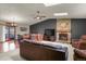 Cozy living space featuring a stone fireplace, and seamless access to a dining area with a view at 34101 Columbine E Trl, Elizabeth, CO 80107