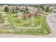 A sprawling yard surrounded by a white fence is enhanced with mature trees and flowering bushes creating a lush outdoor space at 34101 Columbine E Trl, Elizabeth, CO 80107