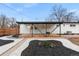 Charming backyard showcasing a covered deck, beautiful landscaping, and a well-maintained lawn at 6511 S Cedar St, Littleton, CO 80120