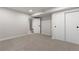 Finished basement featuring neutral walls and carpet with access to another room via a white door at 6511 S Cedar St, Littleton, CO 80120