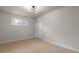 Well-lit bedroom showcasing a large window, stylish lighting, and a closet with sliding doors at 6511 S Cedar St, Littleton, CO 80120