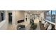 Open-concept living space with modern furniture, a decorative fireplace, and plenty of natural light at 6511 S Cedar St, Littleton, CO 80120