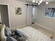 Comfortable bedroom featuring a sliding barn door, contemporary lighting, and neutral decor at 6511 S Cedar St, Littleton, CO 80120