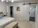 Serene main bedroom featuring a sliding barn door to the en-suite bathroom with marble shower at 6511 S Cedar St, Littleton, CO 80120