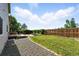 Well-manicured backyard with mature landscaping, a brick patio and deck at 22501 E Belleview Pl, Aurora, CO 80015