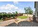 Landscaped backyard area with a small deck, patio and privacy fence at 22501 E Belleview Pl, Aurora, CO 80015