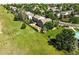 Aerial view of a fenced backyard with green lawn, trampoline, patio and mature trees at 22501 E Belleview Pl, Aurora, CO 80015