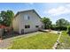 Large backyard with a lush lawn, privacy fence, brick patio, and small deck at 22501 E Belleview Pl, Aurora, CO 80015