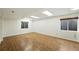 Spacious basement featuring wood flooring, natural light and a drop tile ceiling at 22501 E Belleview Pl, Aurora, CO 80015