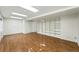 Finished basement offering wood flooring and built in shelving for ample storage space at 22501 E Belleview Pl, Aurora, CO 80015