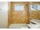 Bathroom featuring a tub, shower, and tile surround, plus vanity with sink at 22501 E Belleview Pl, Aurora, CO 80015