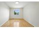 Bright and airy bedroom with hardwood floors and large window providing ample natural light at 22501 E Belleview Pl, Aurora, CO 80015