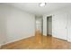 Empty bedroom with hardwood floors, closet and neutral paint ready for personal touches at 22501 E Belleview Pl, Aurora, CO 80015