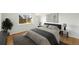 This bedroom boasts a window, wood floors, neutral walls, and decor creating a cozy and inviting atmosphere at 22501 E Belleview Pl, Aurora, CO 80015