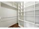 Walk-in closet featuring ample shelving, multiple levels, and a functional design for optimal storage at 22501 E Belleview Pl, Aurora, CO 80015