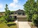 Two story home with a two car garage, lush trees and well-maintained lawn at 22501 E Belleview Pl, Aurora, CO 80015