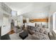 Bright living room with high ceilings, open layout to the kitchen, and stylish modern furnishings at 22501 E Belleview Pl, Aurora, CO 80015