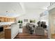 Open-concept living room and kitchen area with hardwood floors, light walls, and modern furnishings at 22501 E Belleview Pl, Aurora, CO 80015