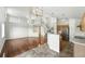 Spacious open-concept design with hardwood floors, light walls, staircase, and modern lighting at 22501 E Belleview Pl, Aurora, CO 80015