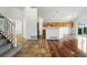 Open-concept design with tile flooring, hardwood floors, light walls, and staircase on the left at 22501 E Belleview Pl, Aurora, CO 80015