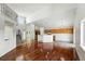 Bright living room with high ceilings, open layout to the kitchen, and beautiful hardwood floors at 22501 E Belleview Pl, Aurora, CO 80015