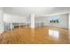 Bright living room featuring beautiful hardwood floors and large windows with neighborhood views at 22501 E Belleview Pl, Aurora, CO 80015