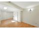 Finished room featuring white paneled walls, neutral color palette and wood-look flooring at 22501 E Belleview Pl, Aurora, CO 80015