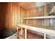 Home sauna with wood paneled walls, tile floor and wood benches at 22501 E Belleview Pl, Aurora, CO 80015