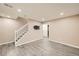 Finished basement features LVP flooring, a staircase, and neutral paint at 16373 E 17Th Pl # B, Aurora, CO 80011