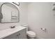 Updated bathroom with gray vanity and arch mirror at 16373 E 17Th Pl # B, Aurora, CO 80011